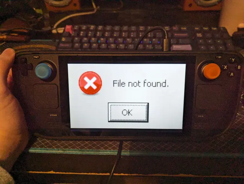 a photo of my steam deck with a wine error saying "File not found" stretched all over the screen making it appear comically large 